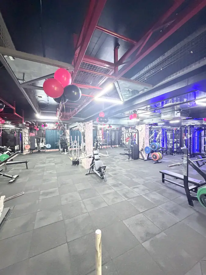 A wide view across the equipment floor towards the mirrored wall