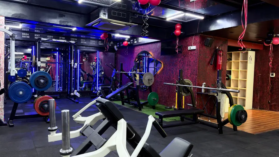 Plate-loaded machines and a wooden plyo box across the strength floor