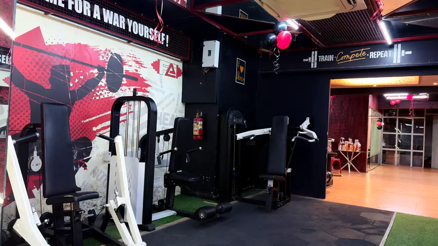The red wall mural on the strength floor next to a plate-loaded machine